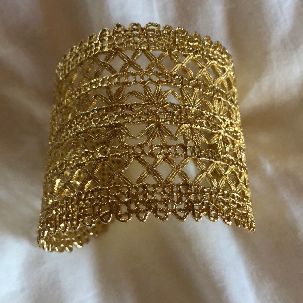 Gold cuff bracelet with intricate filigree design
